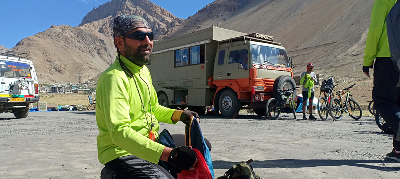 <img src="cycling expedition with caravan campervan ladakh.jpeg" alt="offbeat stay in campervan camp and overland truck on the move in wilderness nomadic with all comforts of caravan camping best energy food logistical support ladakh">      