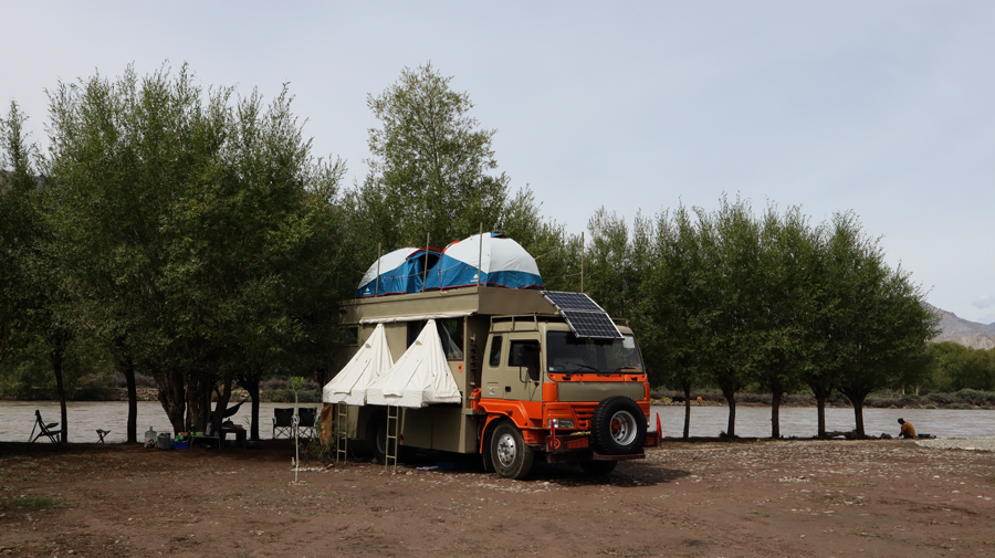 caravan motorhome campervan deployed outside leh ladakh in india for offbeat experiential outdoor nomadic camp corona safe holiday.