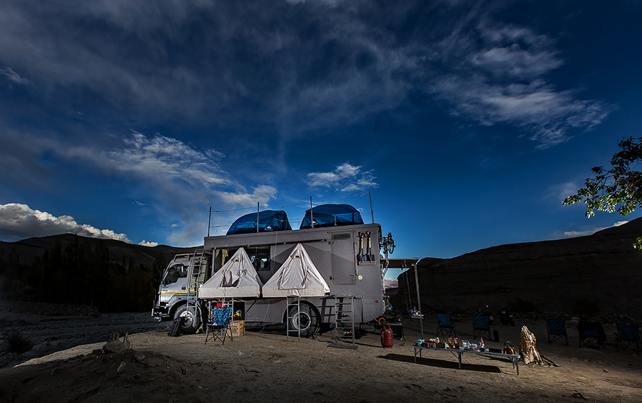best caravan campervan vacation overlanding holiday onboard overland truck vanlife with weber barbecue grill food experience wilderness at sunset sunrise for best family vacation ladakh covid19 corona safe soft adventure.