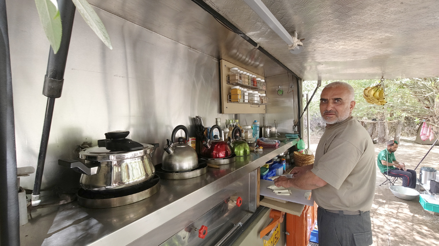 kitchen of our overland truck caravan. Offbeat private campervan  camping with caravan rv recreational vehicle motorhome sand dunes nomadic holiday for families couples.