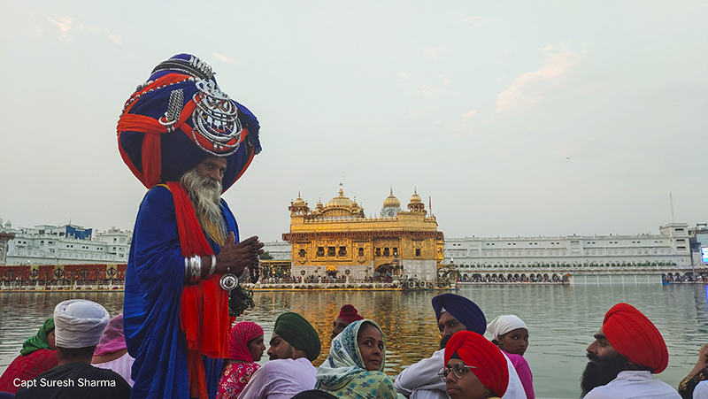 nihang singh warrior in traditional attire represents sikh culture at golden temple on gurupurab amritsar india.  